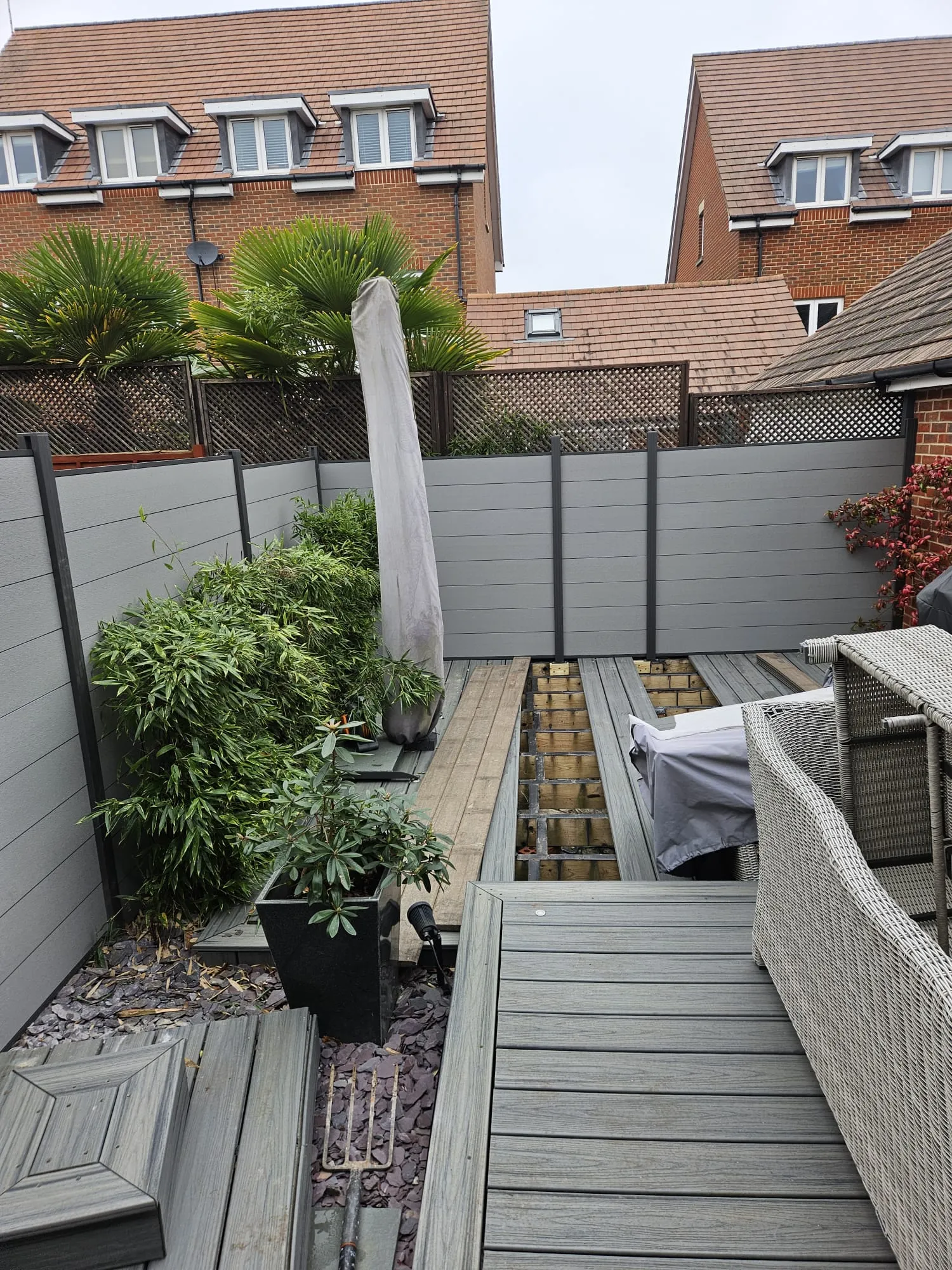 Grey outside building patio area with greenery